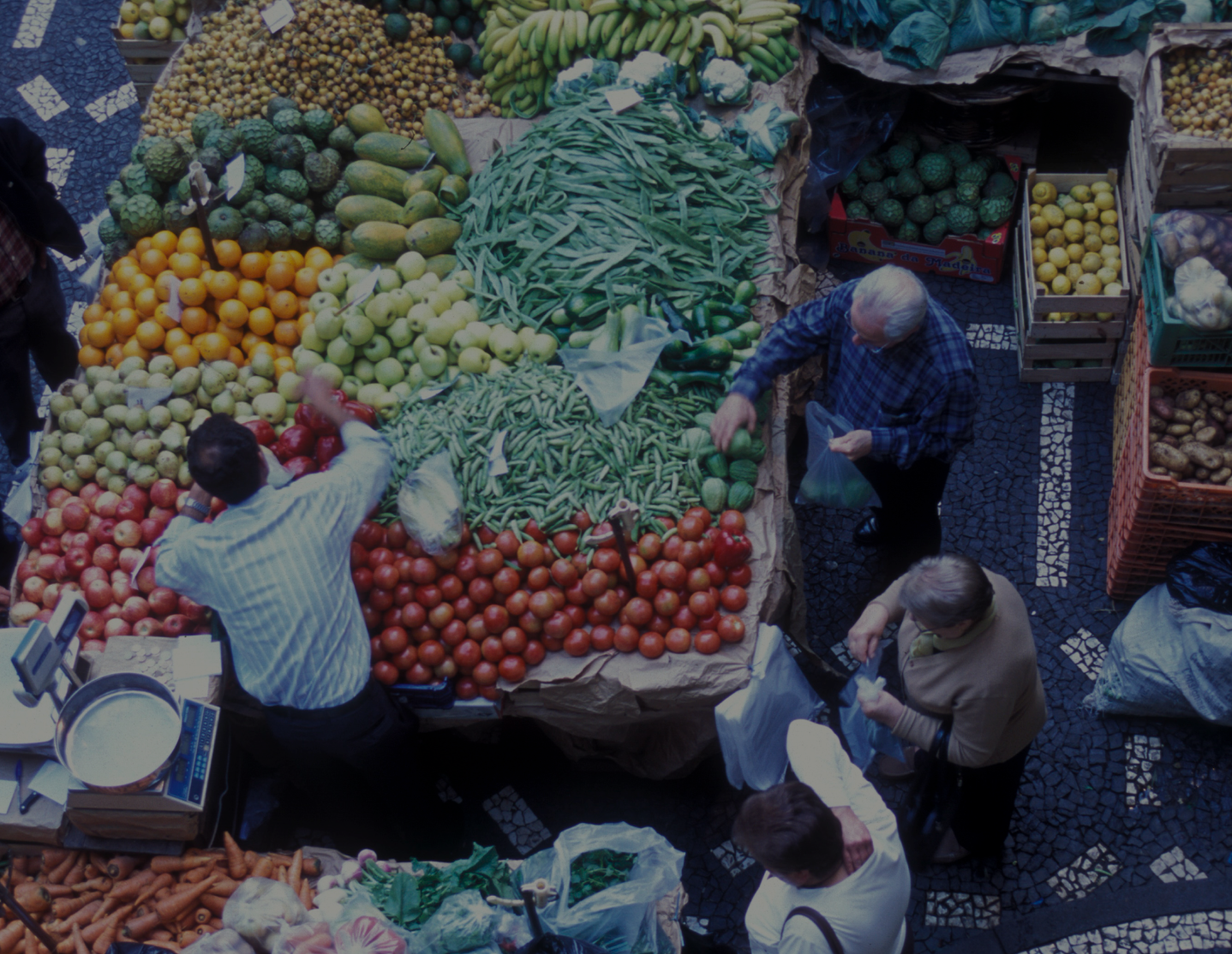 Top view of a market with fresh produce and shoppers